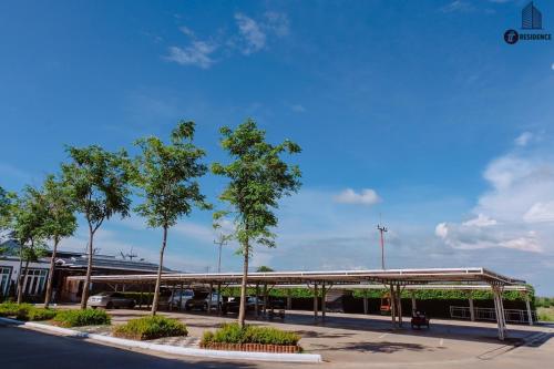 a gas station with trees in a parking lot at tt Residence in Chachoengsao