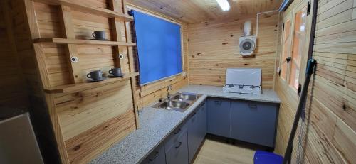 a kitchen in a tiny house with a sink at Camping Cases in Les Cases d'Alcanar