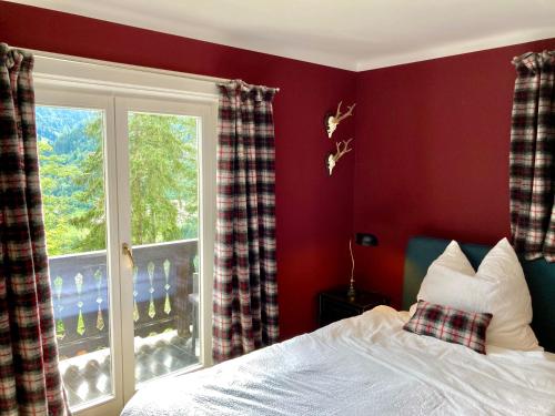 a bedroom with a bed and a window at CHALET OSERIAN in Bad Gastein in Bad Gastein