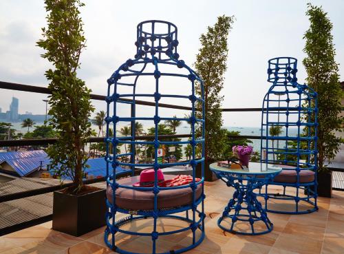 a blue bird cage sitting on top of a roof at The Weekend Pattaya (Tweet Tweet Nest Pattaya) in Pattaya