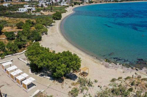 an aerial view of a beach with chairs and trees at Cavos in Agios Sostis