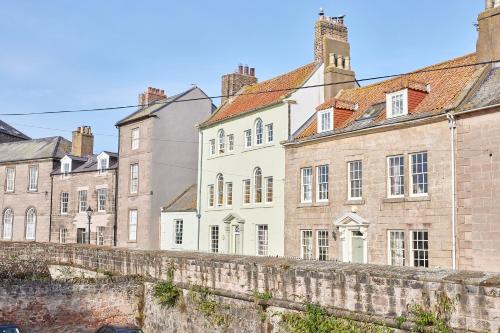 a row of old buildings in a city at River View Characterful Riverside Retreat in Berwick-Upon-Tweed