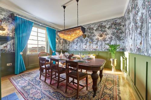 a dining room with a table and chairs at River View Characterful Riverside Retreat in Berwick-Upon-Tweed