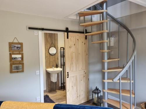 a room with a staircase and a sink and a door at Cozy Nook in Spean Bridge