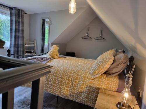 a bedroom with a bed with a teddy bear on it at Cozy Nook in Spean Bridge