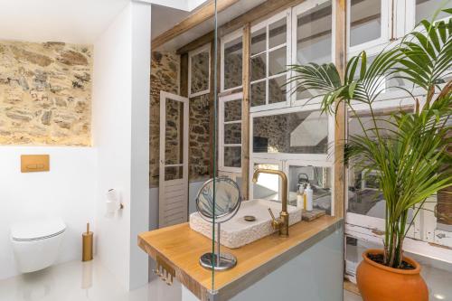 a bathroom with a sink and a mirror at Suites D´aldeia - Suite 16 in Mafra
