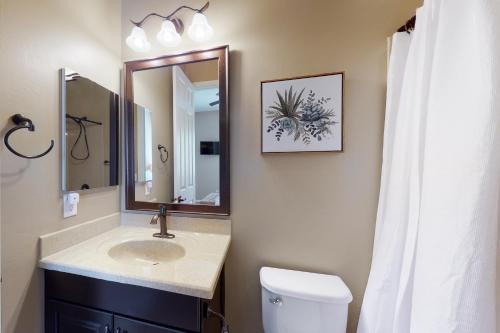 a bathroom with a sink and a mirror and a toilet at Dove Mountain Dream in Marana