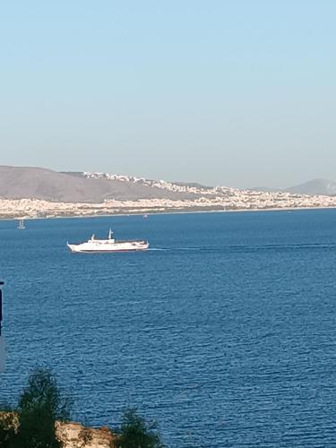 a boat in the middle of a large body of water at Blue Seaview Suites in Piraeus