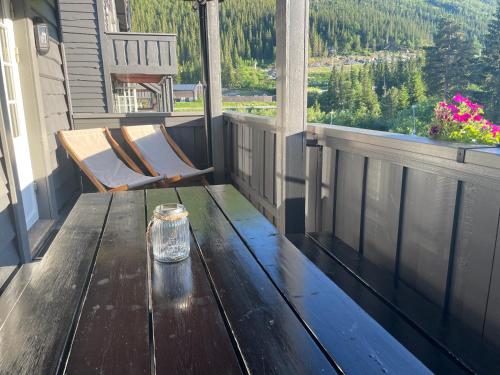 a wooden table on a porch with a glass jar on it at Tinden in Hemsedal