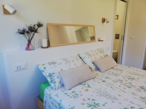 a bedroom with a bed with a mirror at B&B San Gregorio SINNAI in San Gregorio