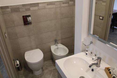 a bathroom with a white toilet and a sink at B&B D'Amari Affittacamere in Palermo
