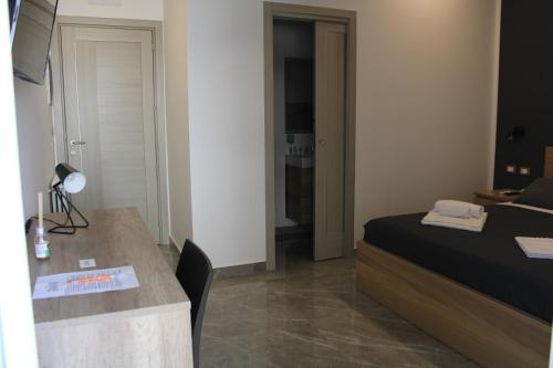 a bedroom with a bed and a desk with a lamp at B&B D'Amari Affittacamere in Palermo
