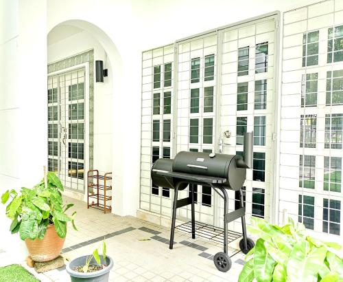 a barbecue grill on the side of a building at 527 BeachHouse l 5 bedroom with swimming pool - 3min walk to the beach in Tanjung Bungah