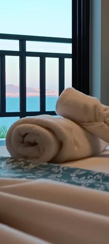 a naked woman laying on top of a bed at Blue Seaview Suites in Piraeus