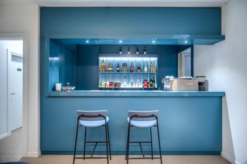 a blue bar with two stools in front of it at Hotel De Lanzi in Florence