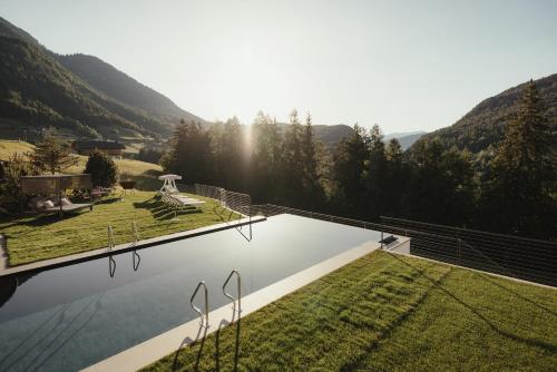 a swimming pool with a view of a mountain at Hotel Digon in Ortisei