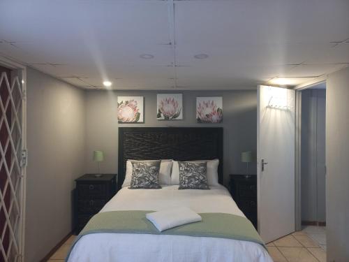 a bedroom with a large bed with two pillows at Our Place - Family - 5 bed unit in Bloemfontein