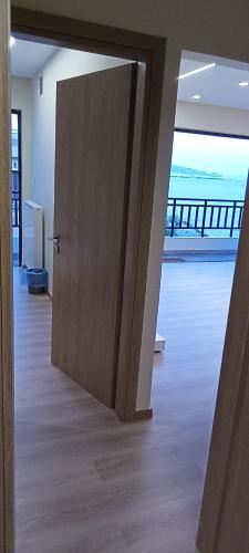 a door in a room with a view of the ocean at Blue Seaview Suites in Piraeus
