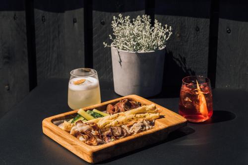 a table with a tray of food and a glass of milk at OTTO Hotel & Sun in Pāvilosta