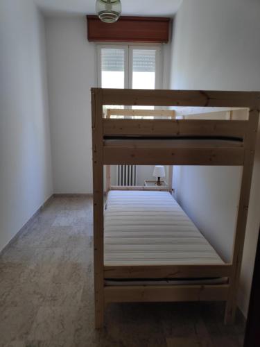 a bunk bed in a room with a window at Appartamento Panoramica in Pesaro