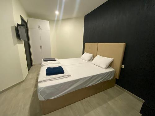 a small bedroom with a bed with a blue pillow at StarHostel in Kutaisi