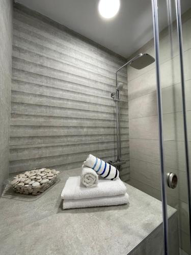 a bathroom with a shower with towels on a counter at Nikiti, four seasons house in Nikiti