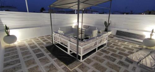 a patio with two chairs and an umbrella at ArcoSalento in Galatina