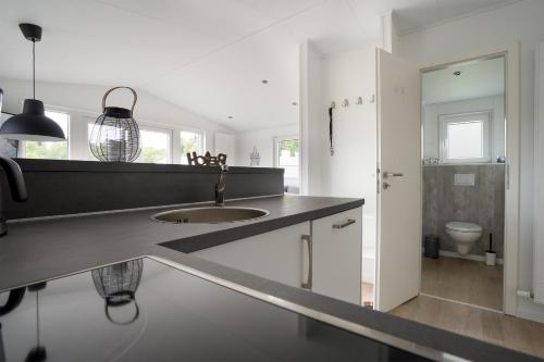 a bathroom with a sink and a toilet at Ostseecamp Lübecker Bucht Meeresbrise in Scharbeutz