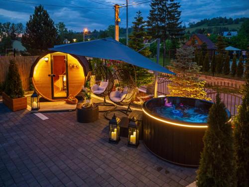 a luxury tent with a hot tub in a backyard at night at GORSKI RESORT Lux Apartments Jacuzzi & Sauna in Poronin