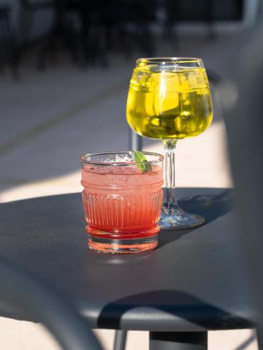a drink and a glass of wine on a table at ibis Carcassonne Est la Cité in Carcassonne