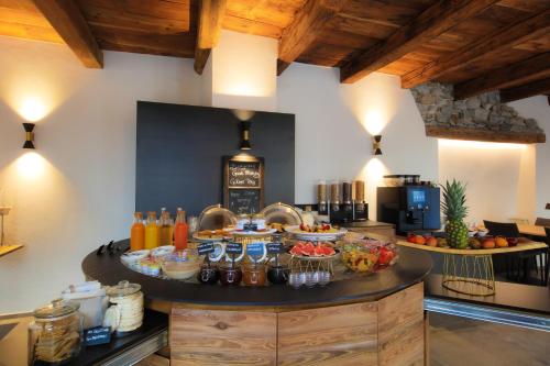 a kitchen with a table with food on it at Charme Hotel al Torchio in Ascona