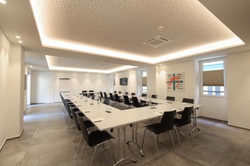 a large conference room with a long table and chairs at Charme Hotel al Torchio in Ascona