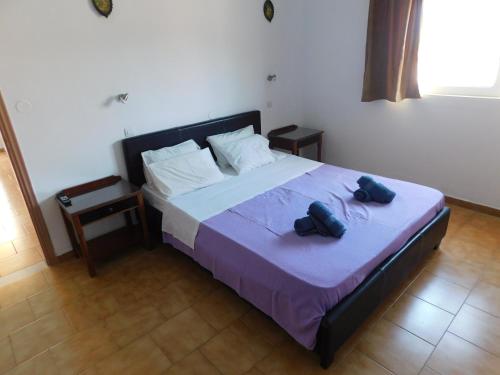 a bedroom with a bed with two bags on it at Villa Sofia in Ialysos