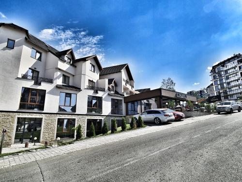 a large white building on the side of a street at Milmari S70 Kopaonik in Kopaonik