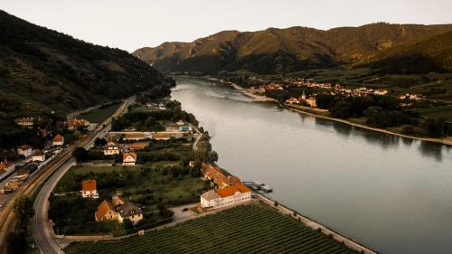 an aerial view of a town next to a river at Donauschlössel in Spitz