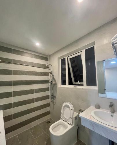 a bathroom with a toilet and a sink at Amora Hotel & Apartment in Vung Tau