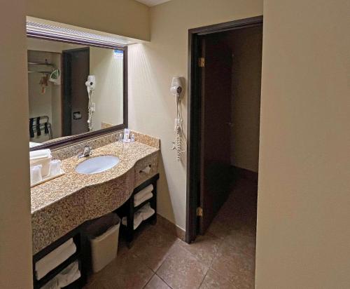 a bathroom with a sink and a mirror at Comfort Inn West Phoenix at 27th Ave and I-I0 in Phoenix
