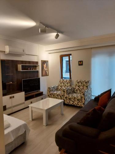 a living room with a couch and a coffee table at CLASS SUİT RESİDENCE in Canakkale