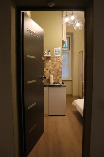 a door leading into a kitchen with a counter at Little Zrin Rooms in Zagreb