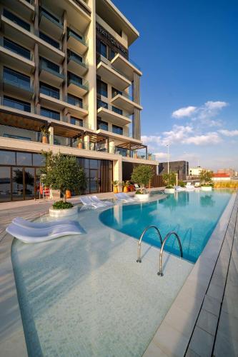 a large swimming pool in front of a building at Hyatt Centric Jumeirah Dubai in Dubai