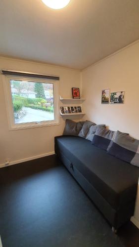 a bedroom with a bed and a window at Villa with great view in Sandnes