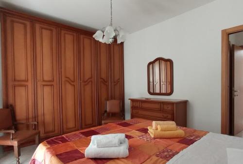 a bedroom with a bed with two towels on it at Appartamento Il Glicine in Montalcino