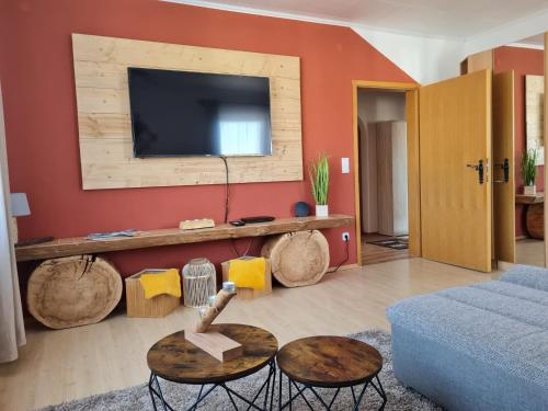 een woonkamer met een blauwe bank en een tv bij Sweet Home Ferienwohnung in Ruderatshofen