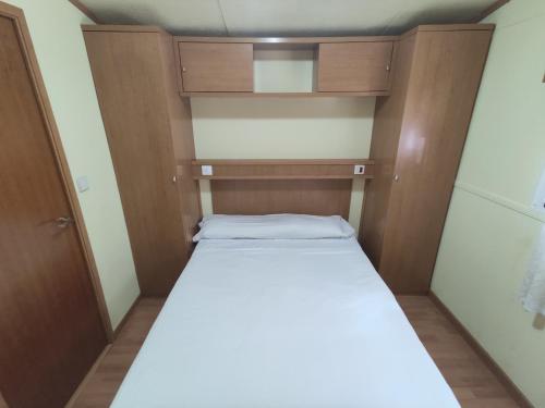 a small bedroom with a bed in a room at Camping Cases in Les Cases d'Alcanar