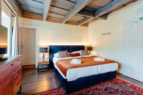 a bedroom with a large bed in a room at Hotel Glaus in Banská Štiavnica