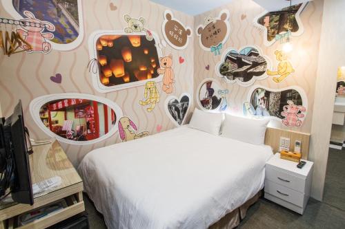 a bedroom with a bed with a wall covered in stickers at Morwing Hotel - Ocean in Taipei