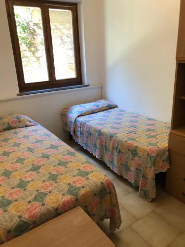 En eller flere senge i et værelse på Appartamento Tella