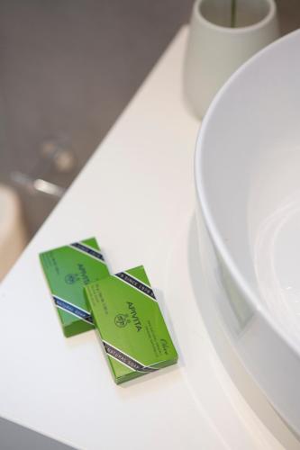 a piece of paper sitting on a table next to a plate at Elianthi Luxury Apartments in Nikiana