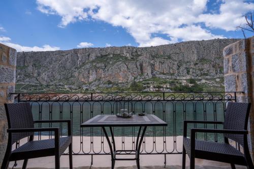 a table and chairs with a view of a mountain at Guesthouse Laoula in Gerolimenas