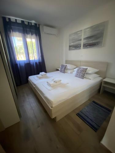 a large white bed in a room with a window at 1oak rentals in Vir